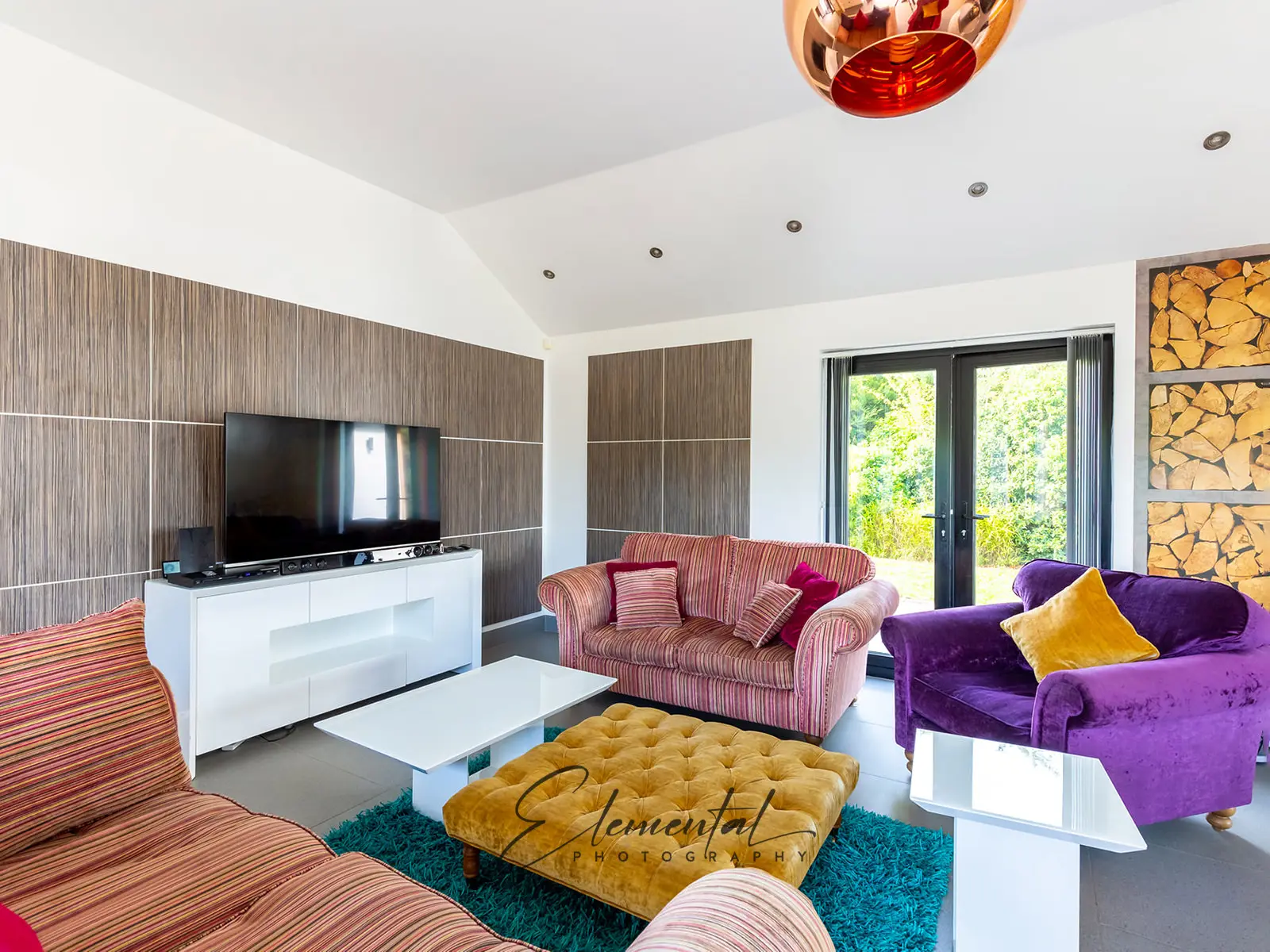 A living room with couches and a television.