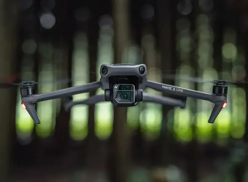 A dji mavic flying over a forest.